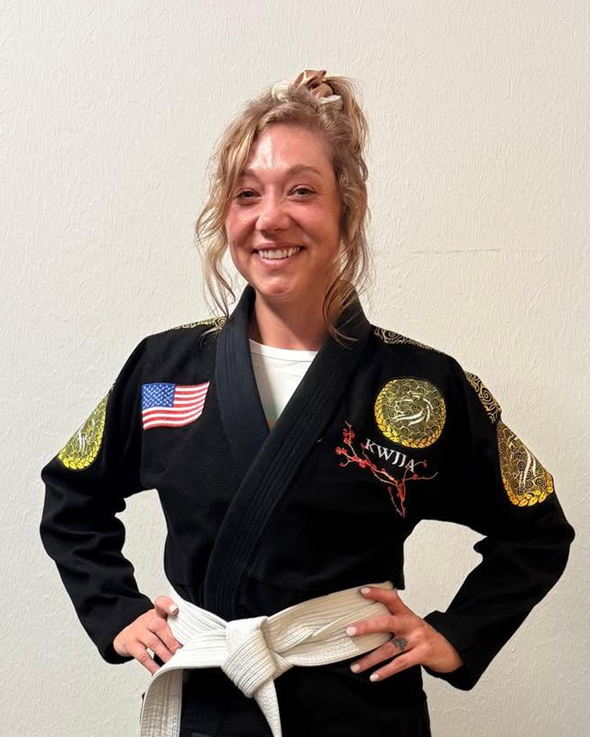 Heather Jones, founder of Still She Walks, wearing her Brazilian jiu jitsu gi and white belt